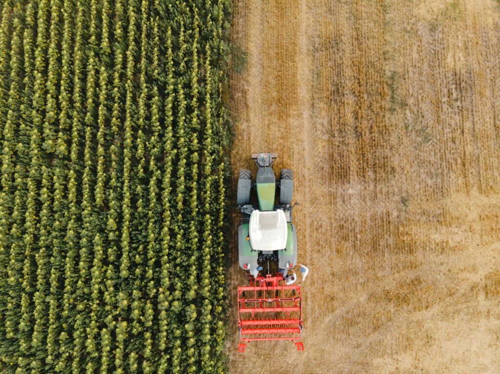 Farmer Tractor Overhead shot of farmer driving red tractor in farm field