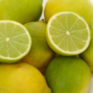 Lemon/lime in a pile, with one cut in half